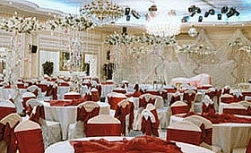 Grand ballroom at Sunset Jeddah, Jeddah, adorned with white drapery and crystal chandeliers