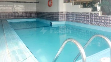 Pool area at Boudl Al-Corniche, Dammam, with blue-tiled wallssemblage and metal handrails