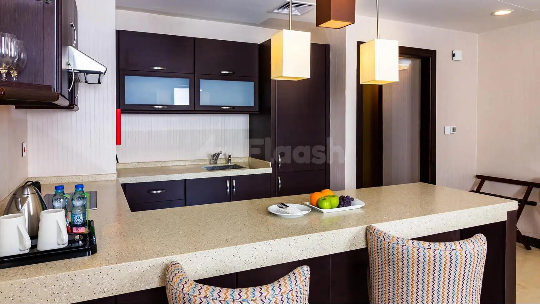 Kitchenette bar at Wyndham Garden Dammam, Dammam, with dark cabinetry and patterned barstools
