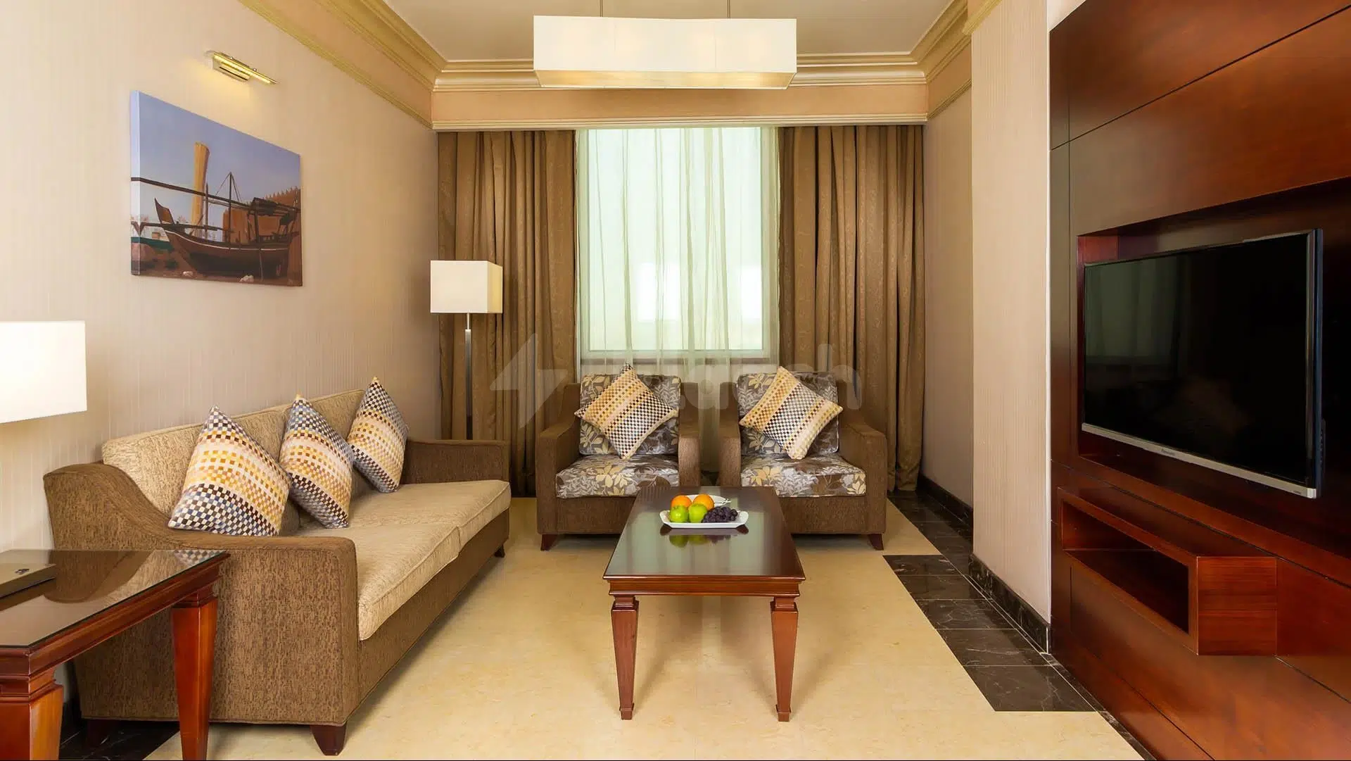 Living room at Wyndham Garden Dammam, Dammam, featuring patterned cushions and a wooden coffee table