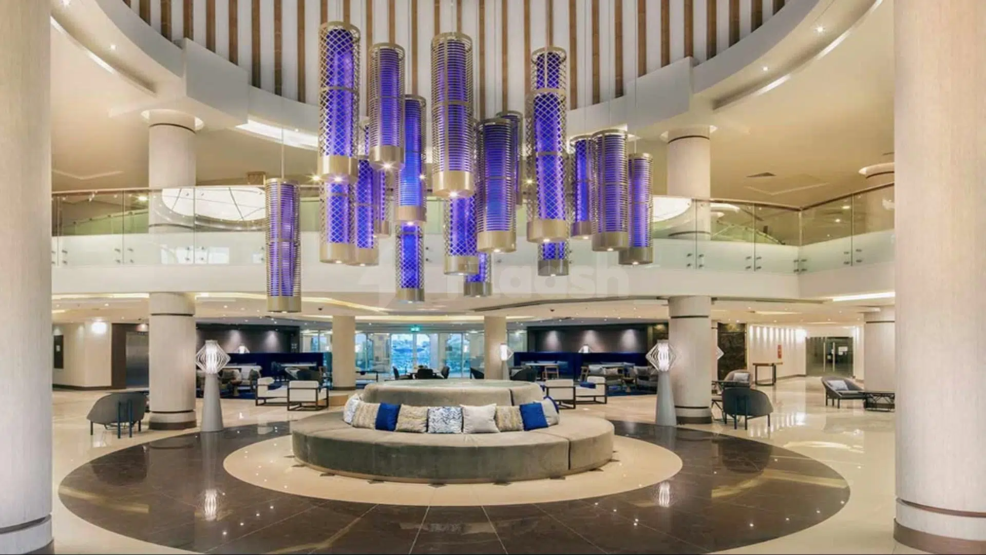 Lobby at Radisson Blu Resort Al Khobar Half Moon Bay, Al Khobar, featuring purple cylindrical chandeliers and circular