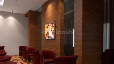 Lobby seating area at Elaf Jeddah Hotel, Jeddah, featuring red armchairs and wood-paneled walls with artwork display