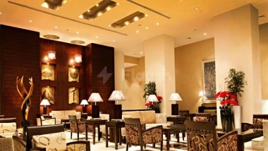 Lobbying space at Elaf Jeddah Hotel, Jeddah, with red floral arrangements on tables