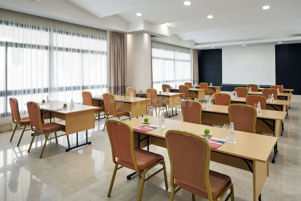 Conference room at Park Inn by Radisson, Makkah Al Naseem, Mecca, with wooden tables and red mesh chairs