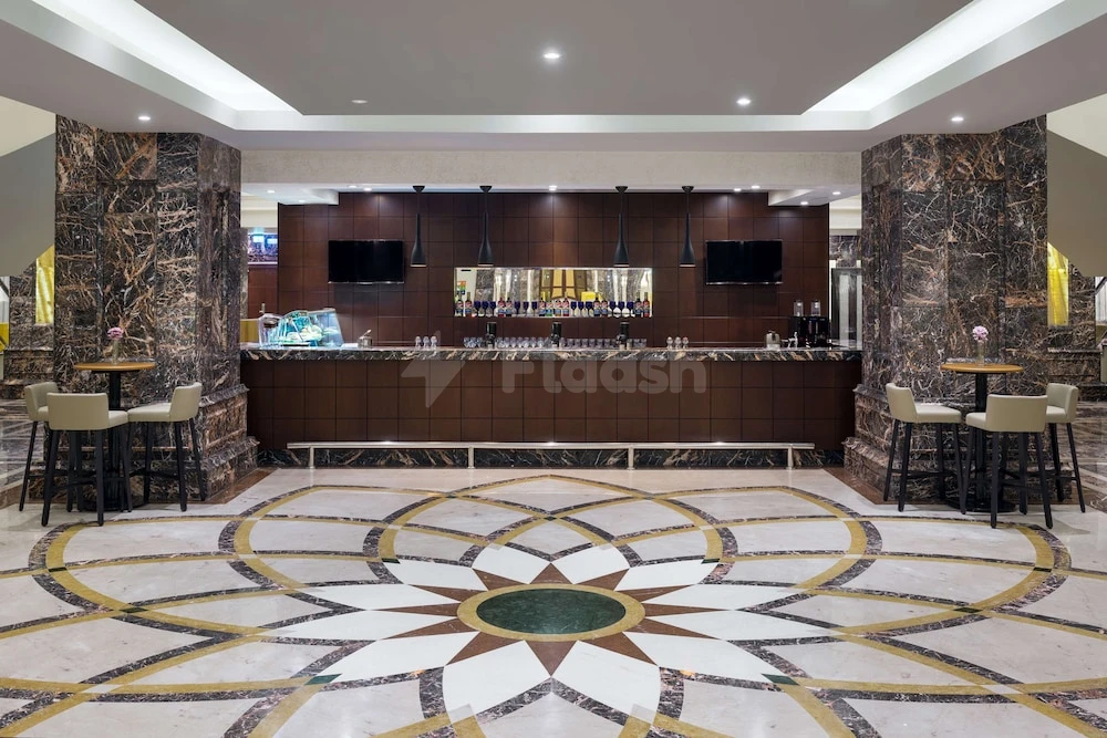 Lobby bar at Park Inn by Radisson, Makkah Al Naseem, Mecca, featuring marble columns and geometric tile flooring
