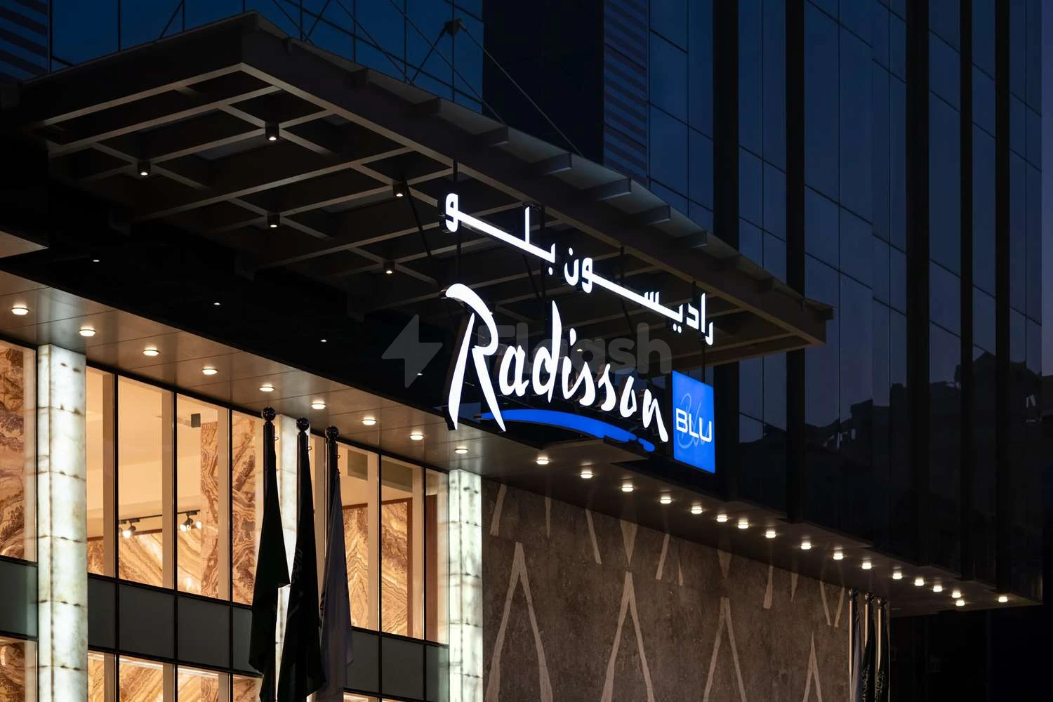 Modern entrance at Radisson Blu Hotel Jeddah Al Hamra, Jeddah, illuminated! by glowing signage and marble