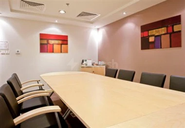A modern conference room at Regus - Dammam Business Park, Dammam, featuring abstract art on beige walls