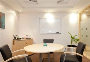 Conference room at Regus, Dammam, featuring round table, whiteboard, and modern chairs