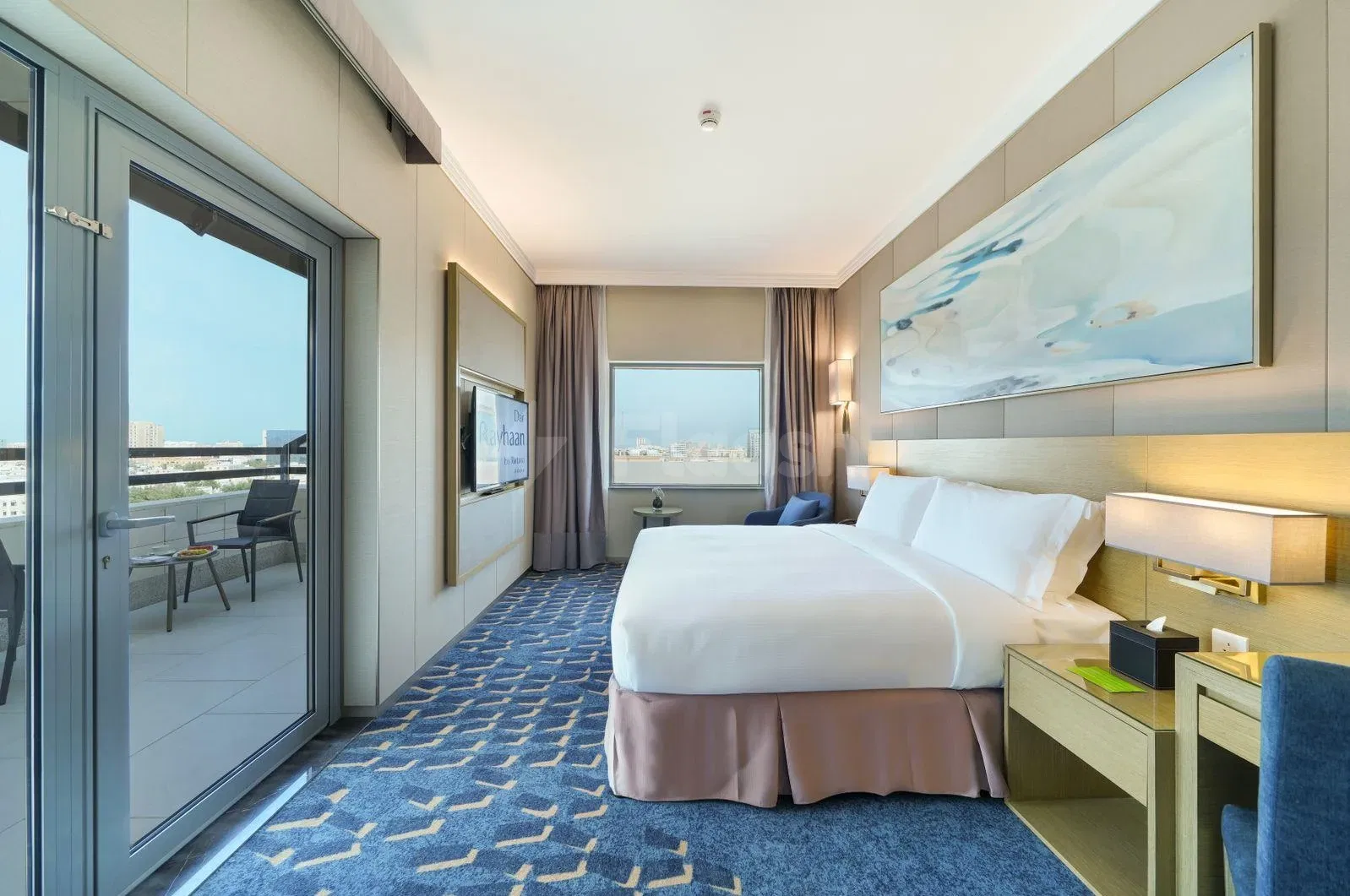 Guest room at Dar Rayhaan by Rotana Al Khobar, Al Khobar, with blue patterned carpet and balcony access