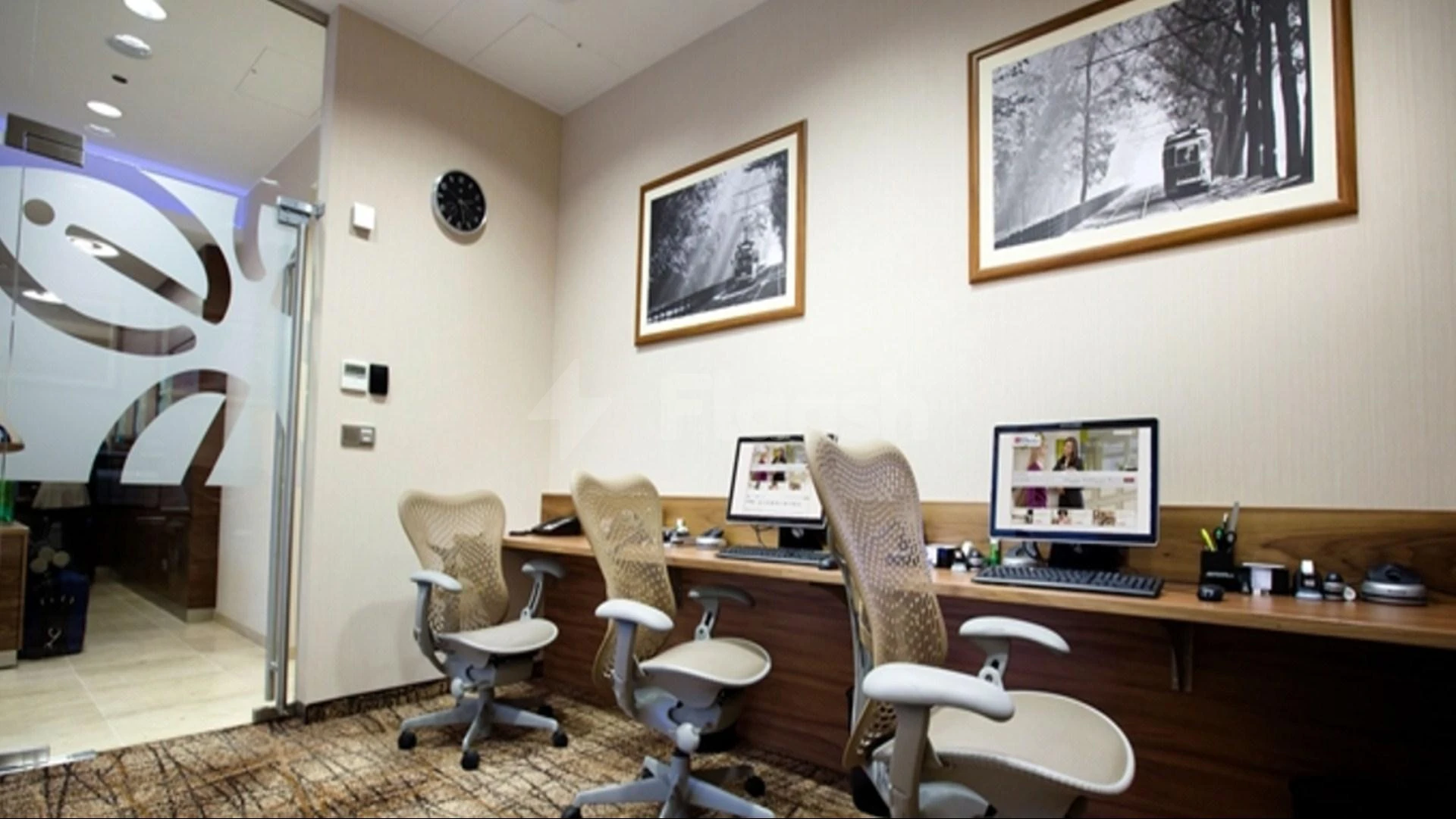Business center at Hilton Garden Inn Al, Al Khobar, with ergonomic chairs and framed black-and-white photography