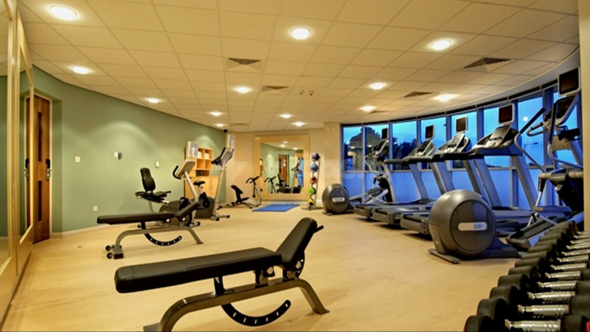 Fitness center at Hilton Garden Inn Al Khobar, Al KHOBAR, with treadmills and weight benches under recessed lighting