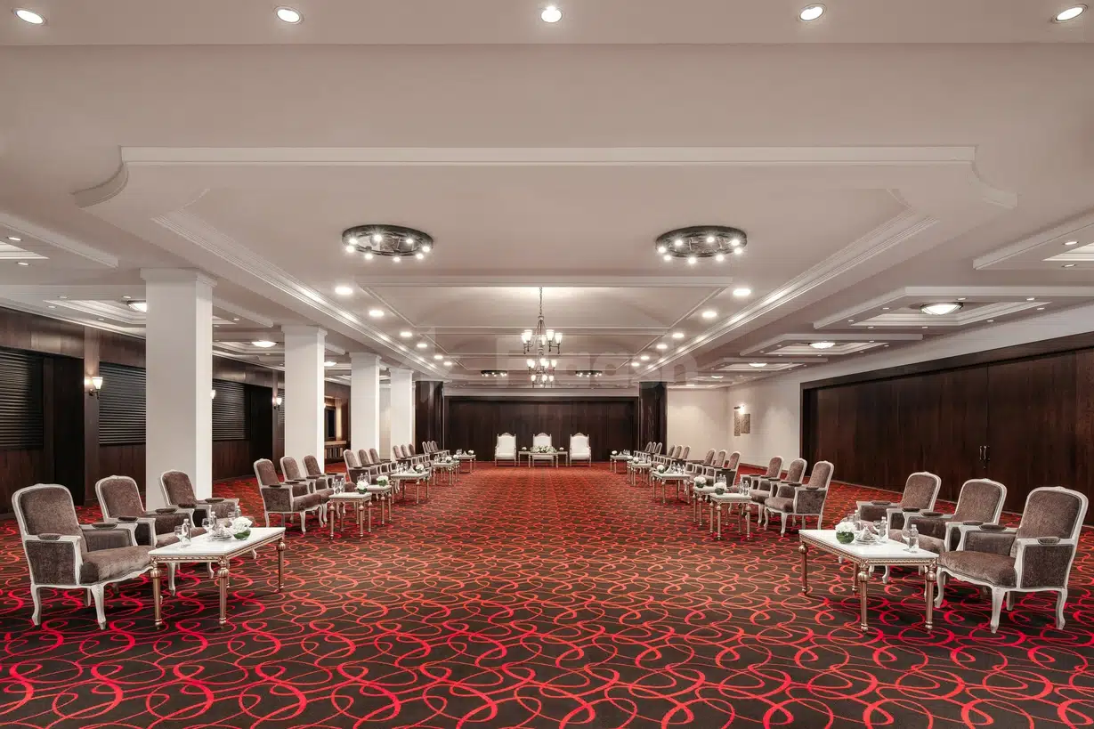 Ballroom at Carlton Al Moaibed Hotel, Dammam, with red patterned carpet and white columns