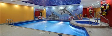 Indoor pool at Al Waha Palace Hotel, Riyadh, with shark mural walls and blue tiled ceiling