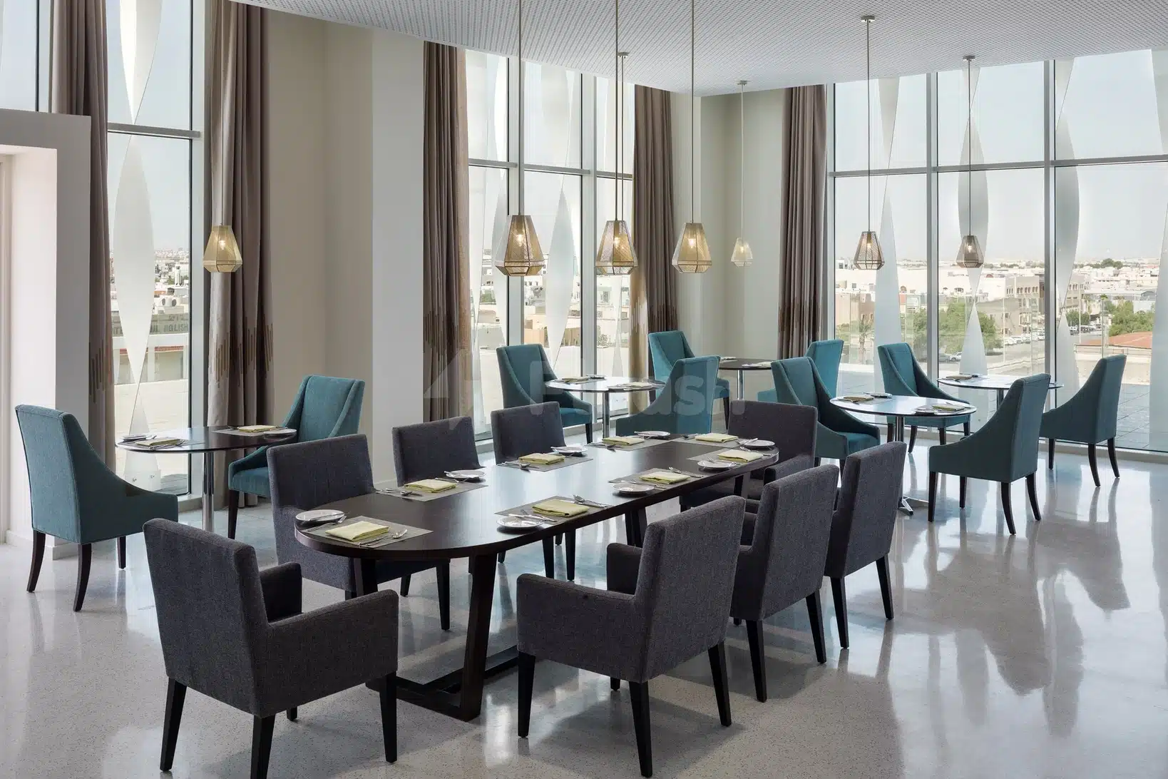 Meeting room at Staybridge Suites Al Khobar, Alukhobar, with floor-to-ceiling windows and modern pendant lights
