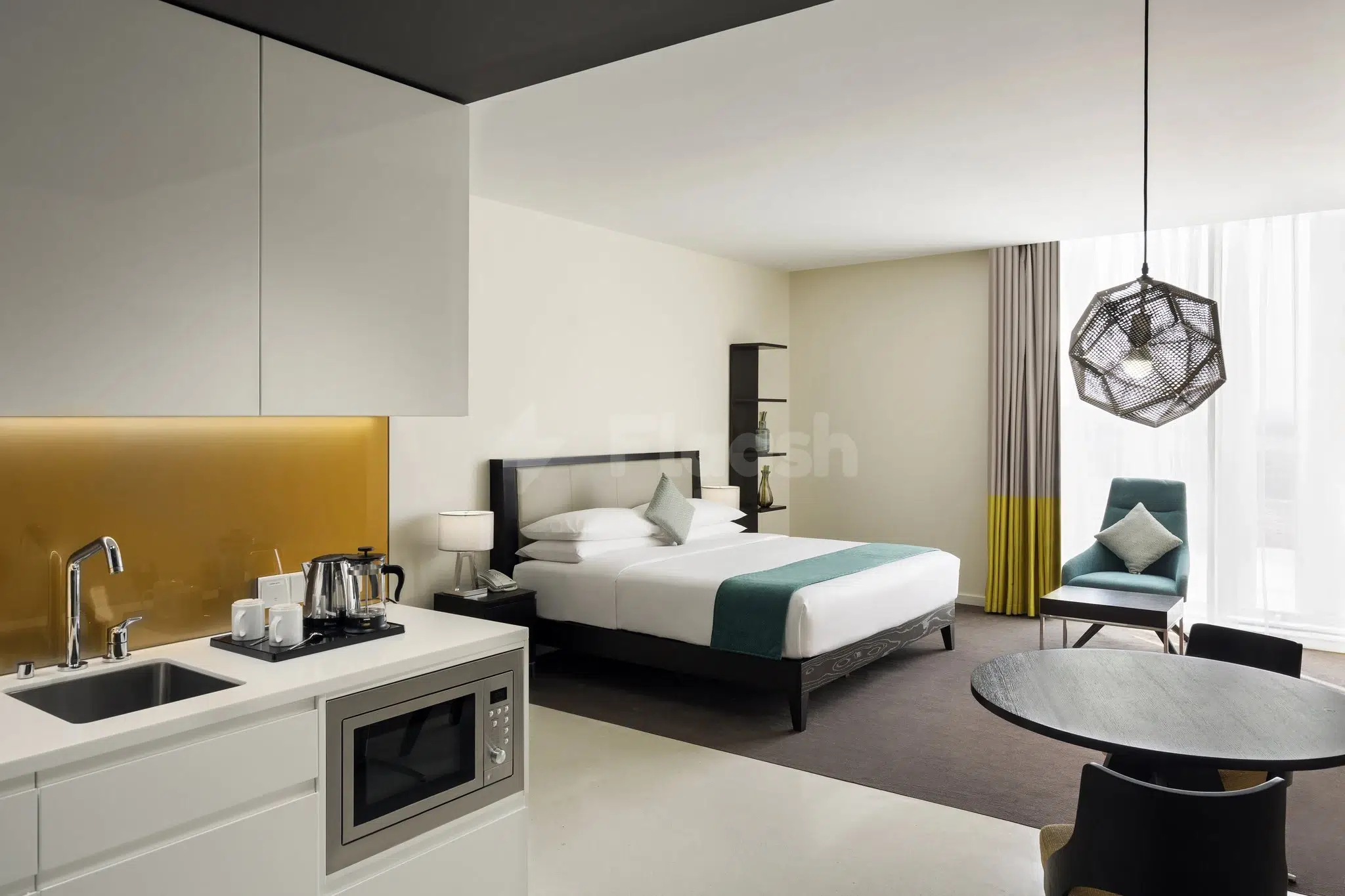 Studio suite at Staybridge Suites Al Khobar, als, featuring a gold backsplash kitchenette and geometric pendant light