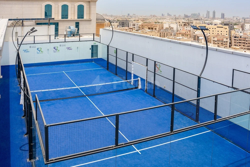Rooftop pickleball courts at Aloft Dhahran, Al Khobar, featuring blue surfaces and city views