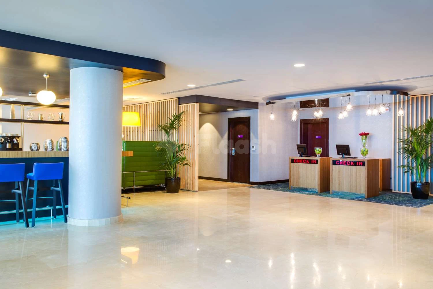 Lobby at Park Inn by Radisson Dammam, Dammam, with check-in desk and blue bar seating under pendant lights