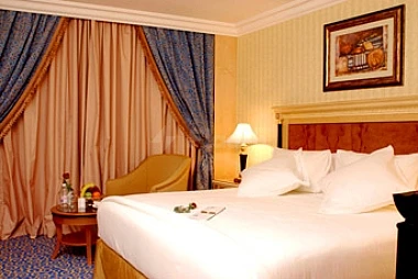 Hotel room at Le Méridien Makkah, Makkah, featuring a neatly made bed with white linens