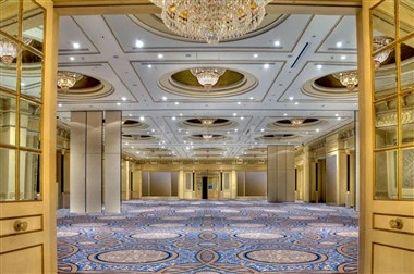 Grand ballroom at Sheraton Dammam Hotel & Convention Centre, Dammam, with ornate ceiling medallities and a patterned blue carpet