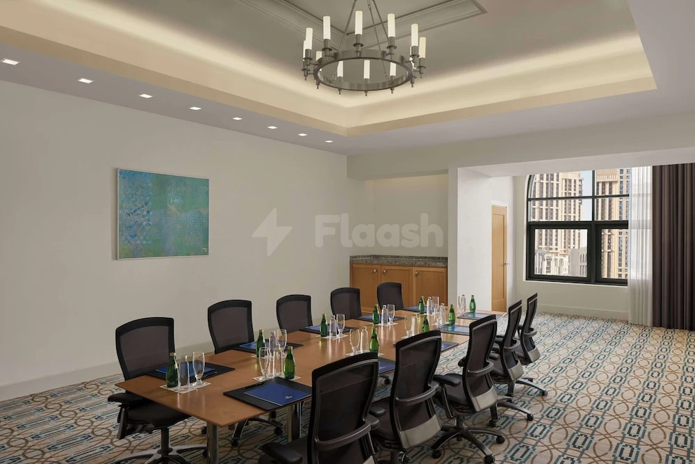 Boardroom at Hilton Hotel & Convention Jabal Omar Makkah, featuring patterned carpet and large window with light fixtures