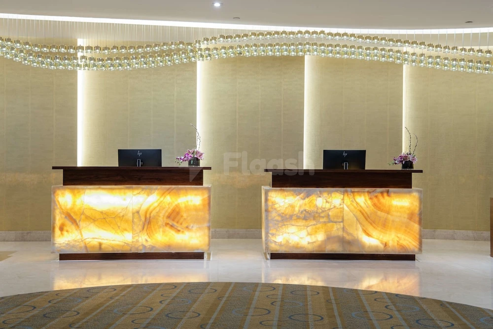 Reception desks at Radisson Blu Hotel, Jeddah Al Salam, Jeddah, with illuminated onyx fronts and crystal chandeliers