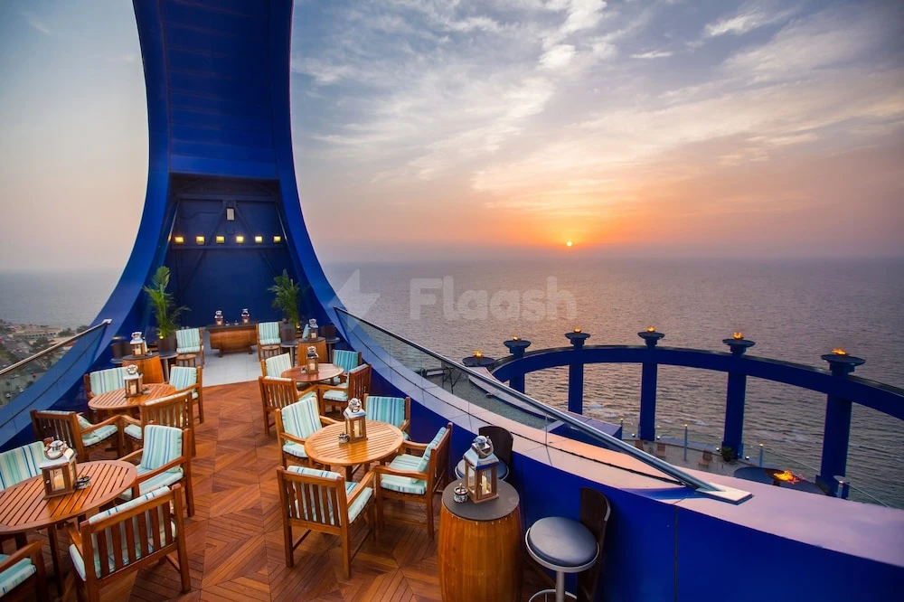 Rooftop terrace at Rosewood Jeddah, Jeddah, with blue arches and ocean sunset view