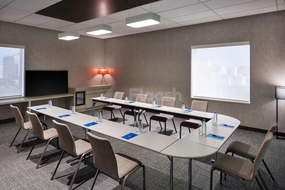 Conference room at Hyatt House Jeddah Sari Street, Jeddah, with U-shaped tables and large windows overlooking cityscape