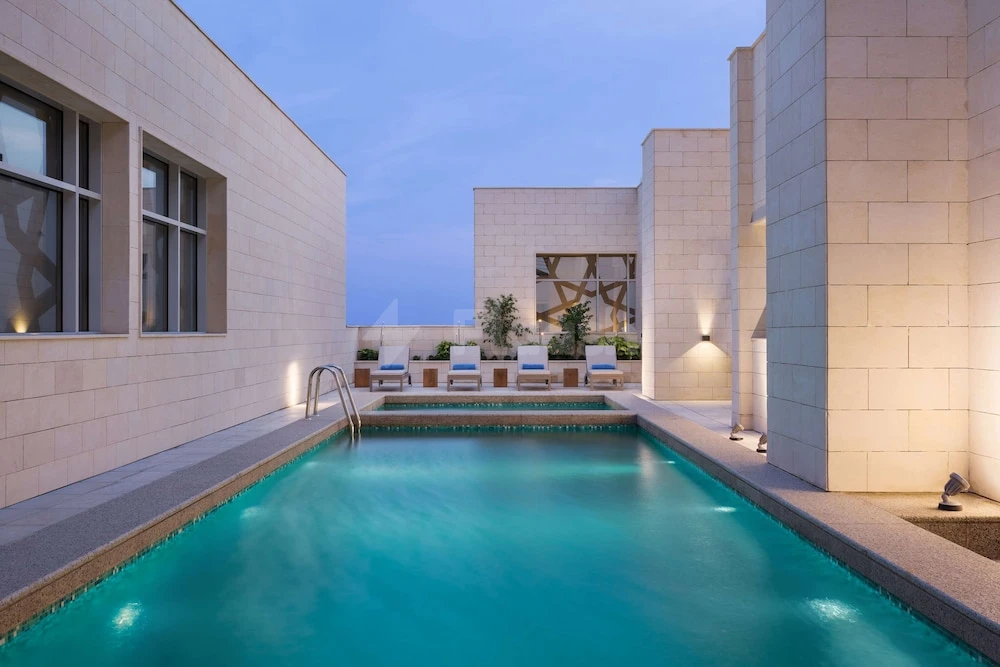 Rooftop pool at Hyatt House Jeddah Sari Street, Jeddah, with lounge chairs and geometric wall art
