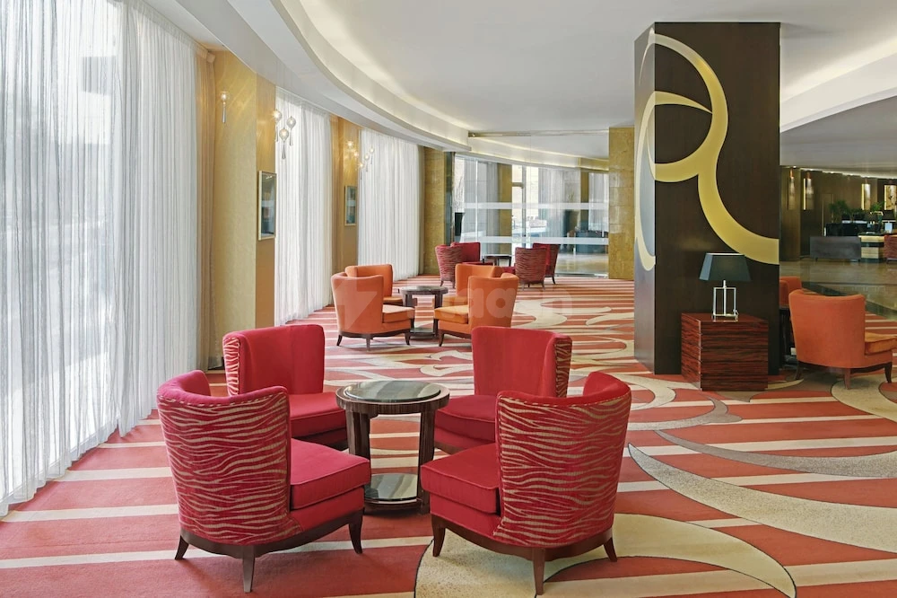 Lobby at Four Points by Sheraton Riyadh Khaldia, Riyadh, featuring red patterned armchairs and abstract carpet design