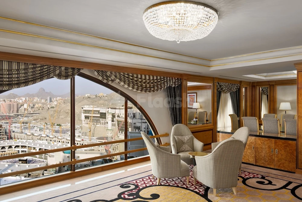 Lobby suite at Makkah Hotel, Makkah, with arched window view of city skyline and crystal chandelier