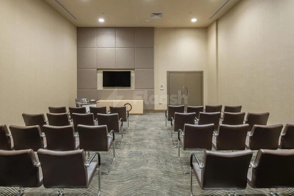 Conference room at Copthorne Makkah Al Naseem, Makkah, with patterned carpet and wall-mounted screen