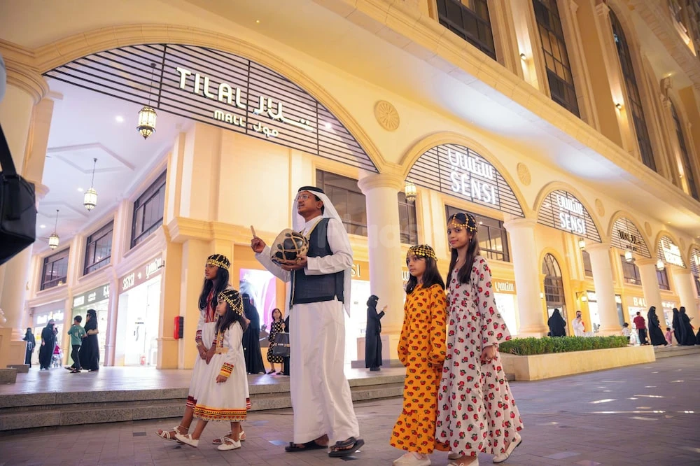 Arcade entrance at Millennium Makkah Al Naseem, Mecca, with arched colonnades and illuminated storefronts