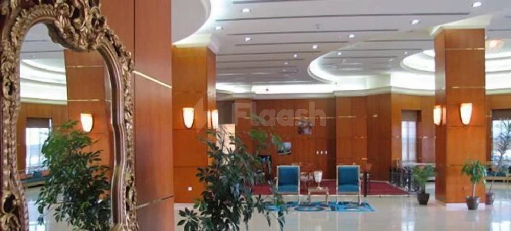 Grand lobby space at Al Massa Hotel, Mecca, featuring ornate mirror and potted plants
