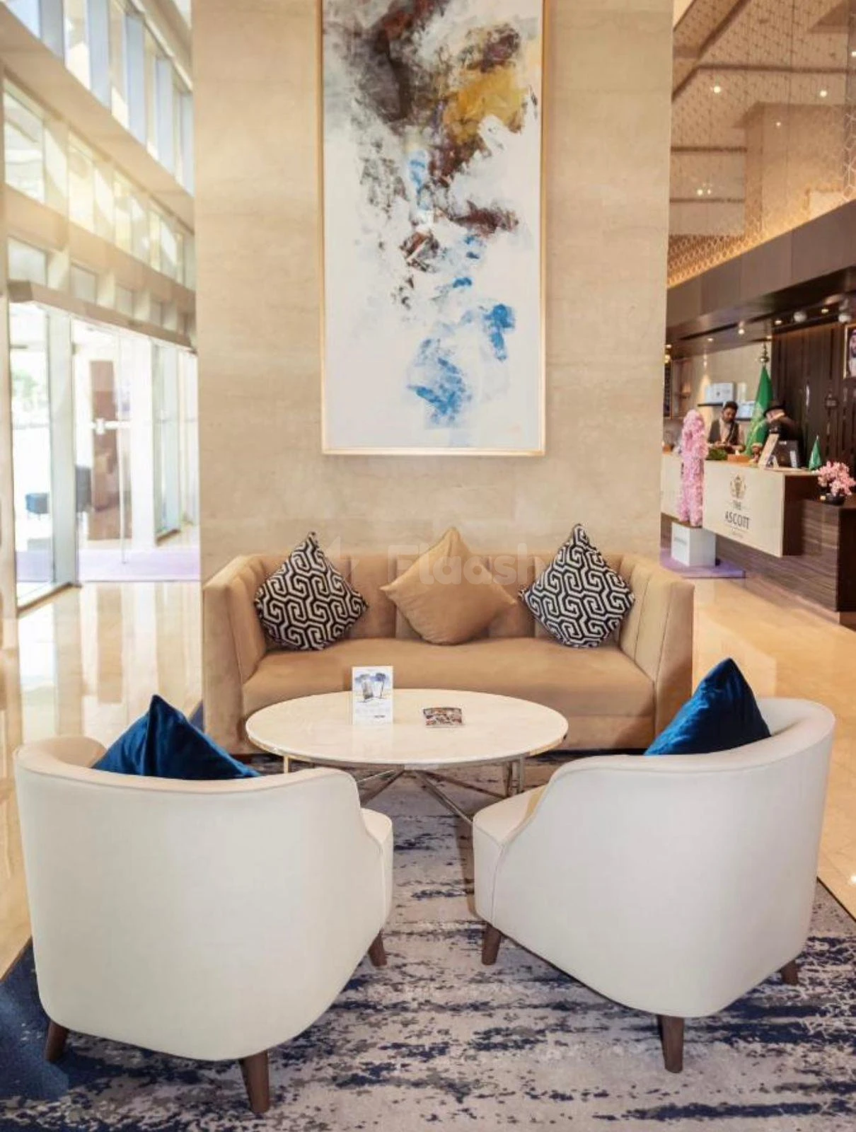 Modern lounge area at Somerset Downtown Al Khobar, Al Khobar, with abstract artwork above beige sofa and white