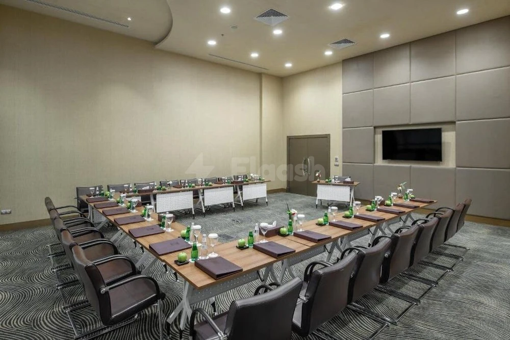 Conference room at Copthorne Makkah Al Naseem, Mecca, with U-shaped tables and wall-mounted screen
