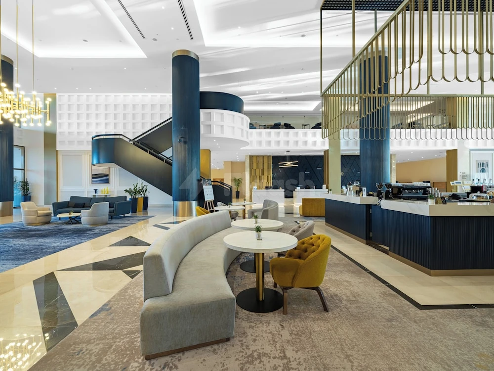 Lobby at voco Jeddah Gate, Djeddah, featuring blue columns and geometric marble flooring