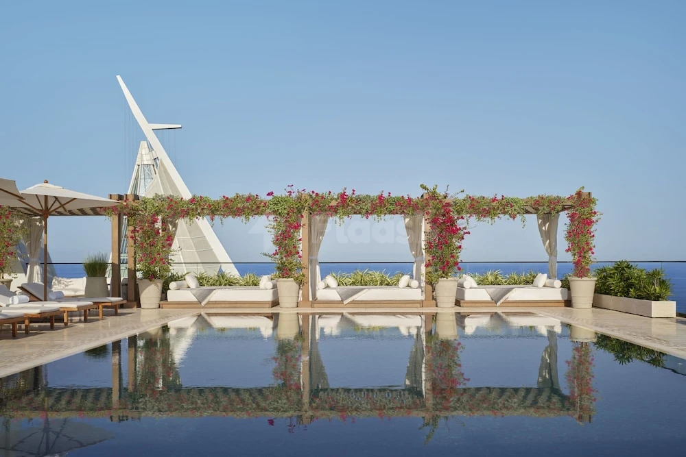 Infinity pool terrace at The Jeddah EDITION, Jeddah, with floral pergola and ocean view
