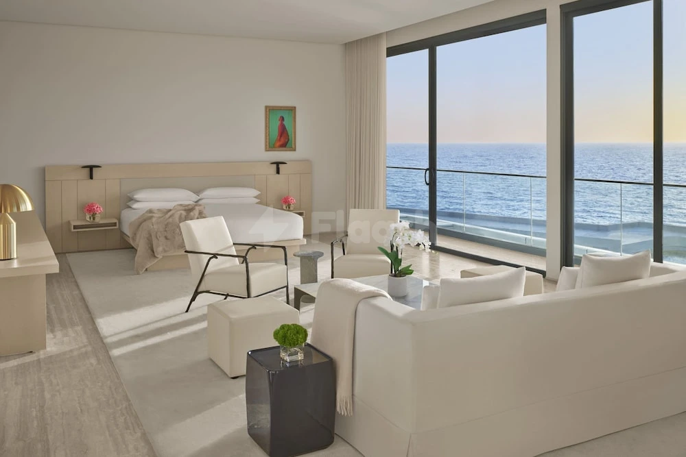 Luxury suite at The Jeddah EDITION, Jeddah, featuring ocean views and minimalist furnishings with a neutral color palette