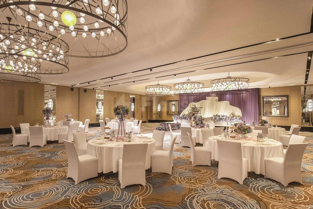 Banquet hall at Assila, a Luxury Collection Hotel, Jeddah, with circular chandeliers and patterned carpeting