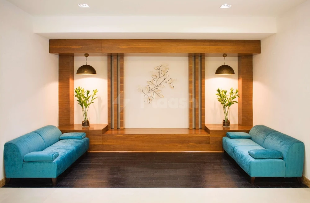 Lobby at Hilton Garden Inn Ras Al Khaimah, Ras Al Khaimah, with turquoise sofas and wooden wall paneling