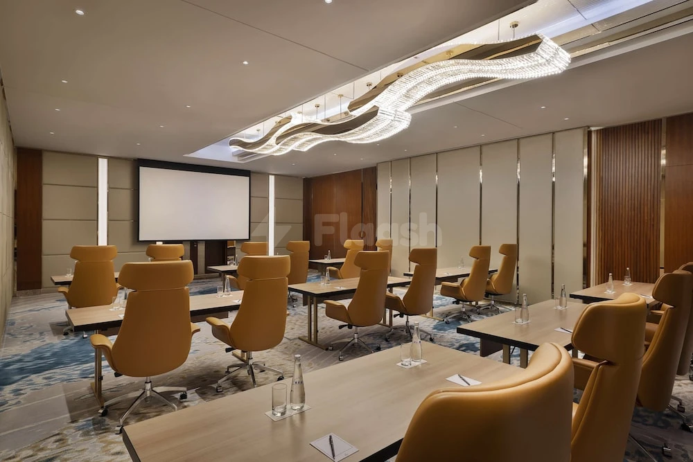 Boardroom at Hilton Dubai Jumeirah, Dubai, with modern chandeliers and leather chairs arranged around tables
