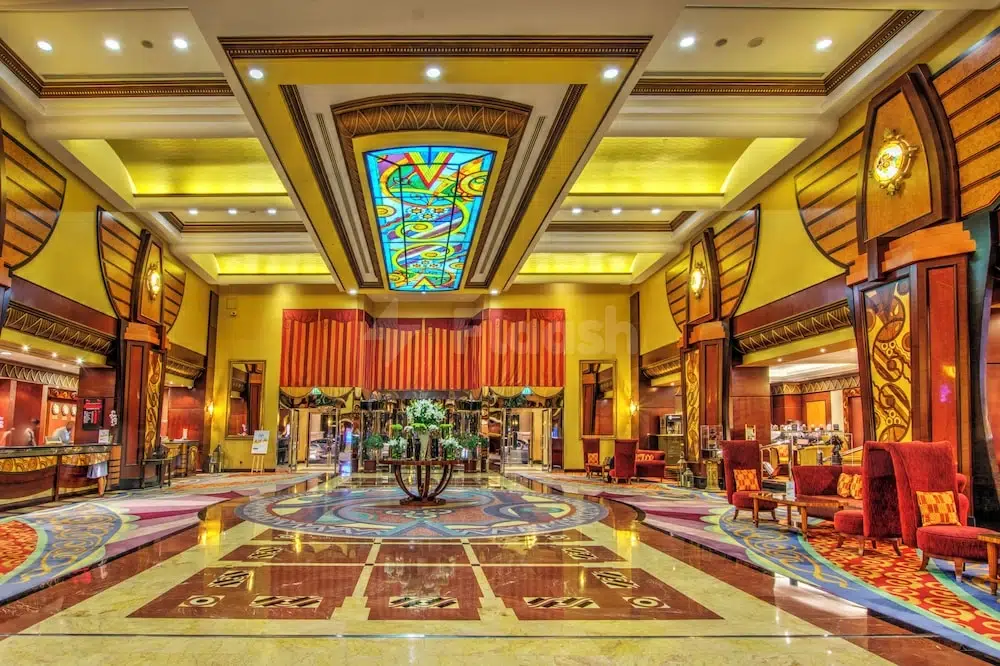 Grand lobby at Al Raha Beach Resort & Spa, Abu Dhabi, featuring stained glass ceiling and ornate marble flooring