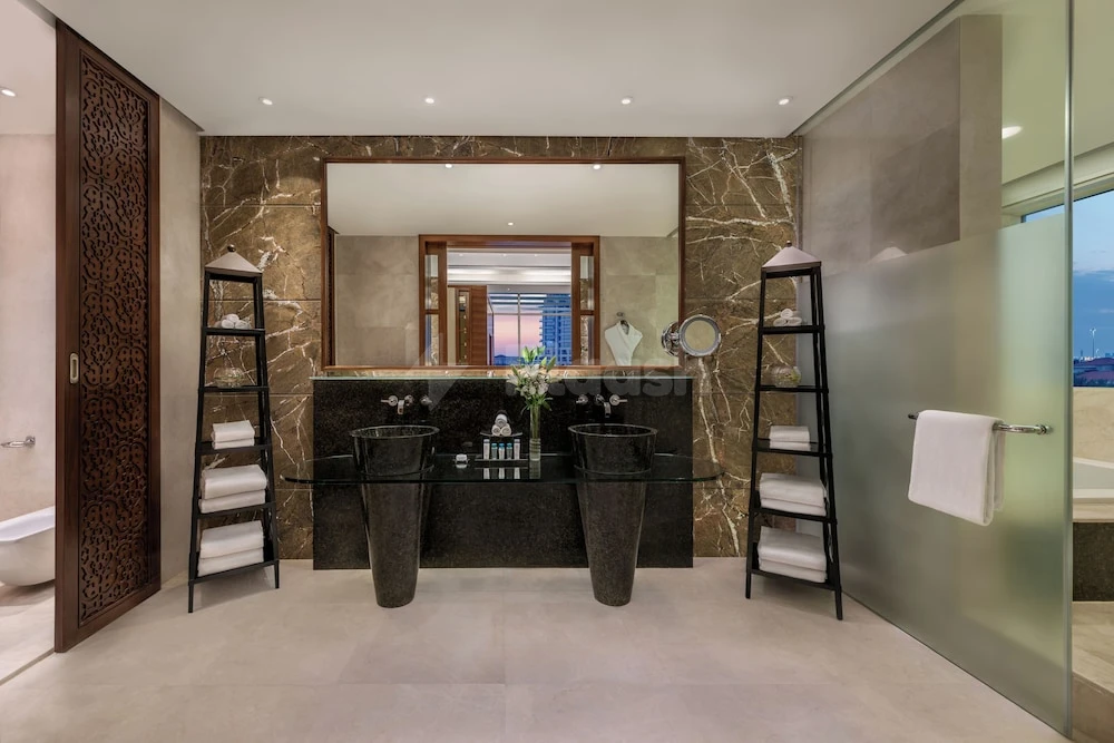 Luxury bathroom at Al Raha Beach Resort & Spa, Abu Dhabi, with marble walls and dual vessel sinks