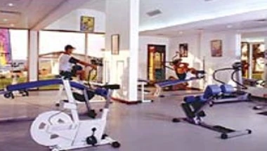 Fitness center at Lou Lou’a Beach Resort, Sharjah, featuring modern equipment and large windows with natural light