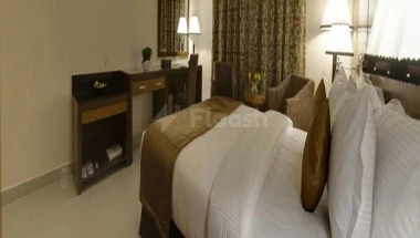 Guest Stephan room, hotel room at City Tower Hotel, Fujairah, with, with bedspread and nightstand lamp