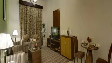 Living room at City Tower Hotel, Fujaira, featuring striped curtains and a vintage TV cabinet