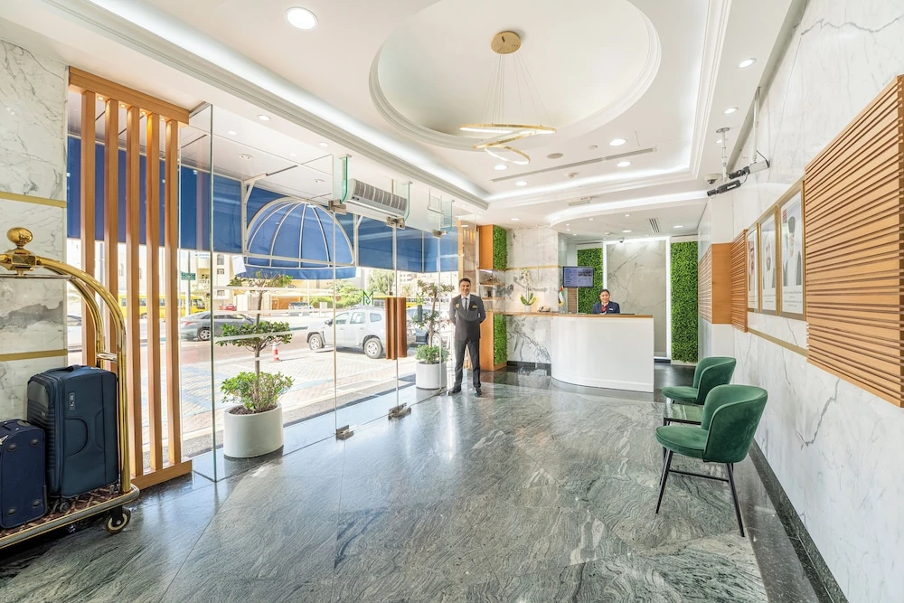 Lobby at Al Nakheel Hotel Apartments, Abu Dhabi, with marble floors and green velvet chairs