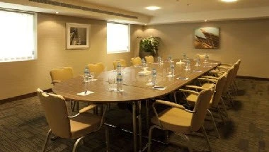 Conference room at Citymax Hotel Sharjah, Sharjah, featuring a long wooden table with bottled water and beige chairs