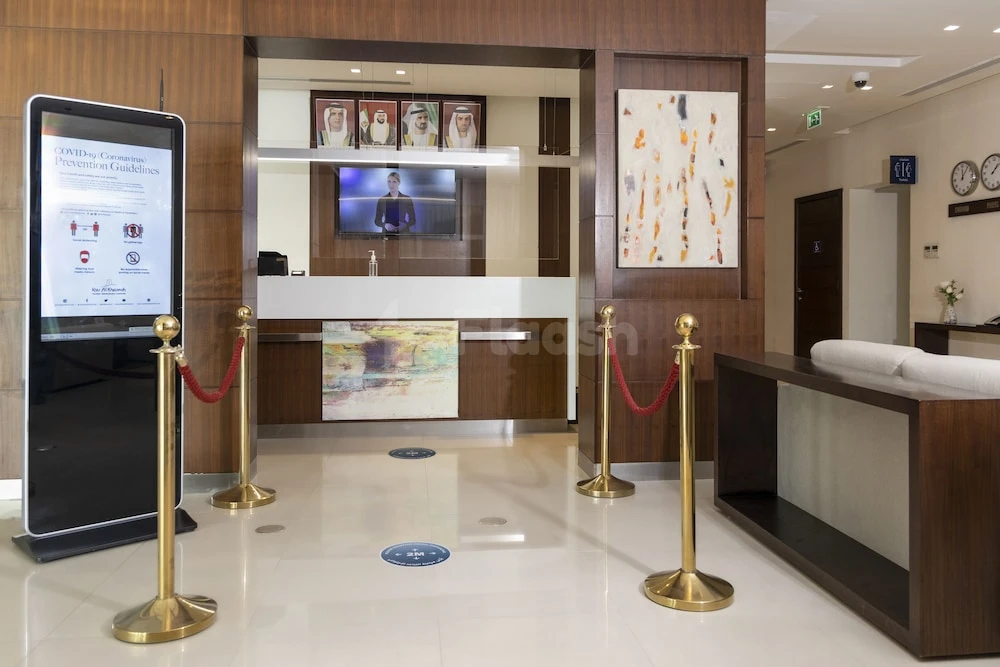 Lobby at Action Hotel Ras Al Khaimah, Ras Al Khaimah, with gold stanchions and digital safety signage