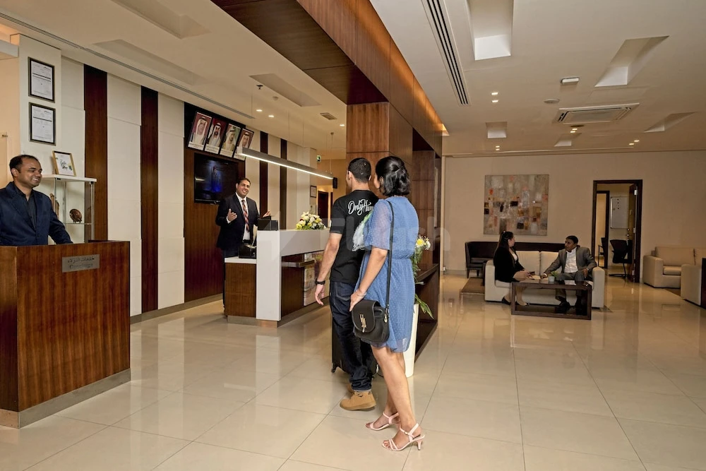 Lobby at Action Hotel Ras Al Khaimah, Ras Al Khaimah, with wooden paneling and reception desk
